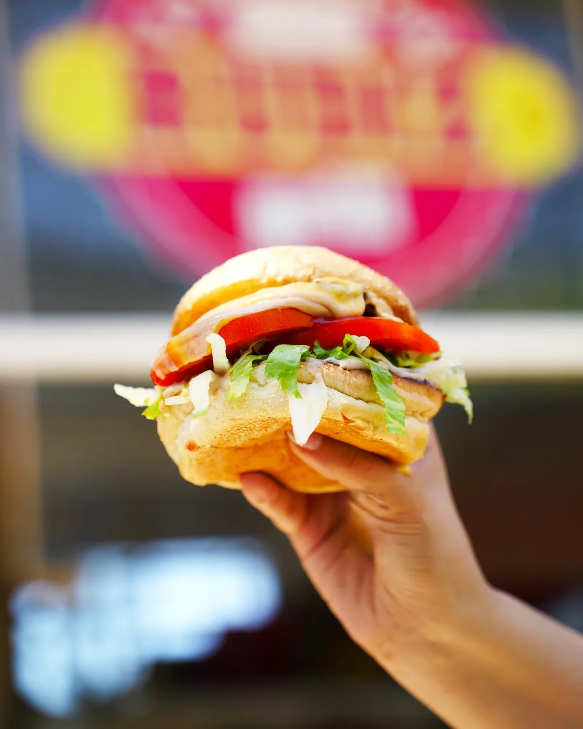 RUDIZ burger held up to camera