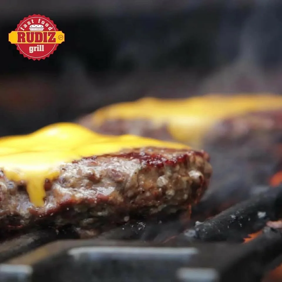 Cheeseburger cooking on the grill